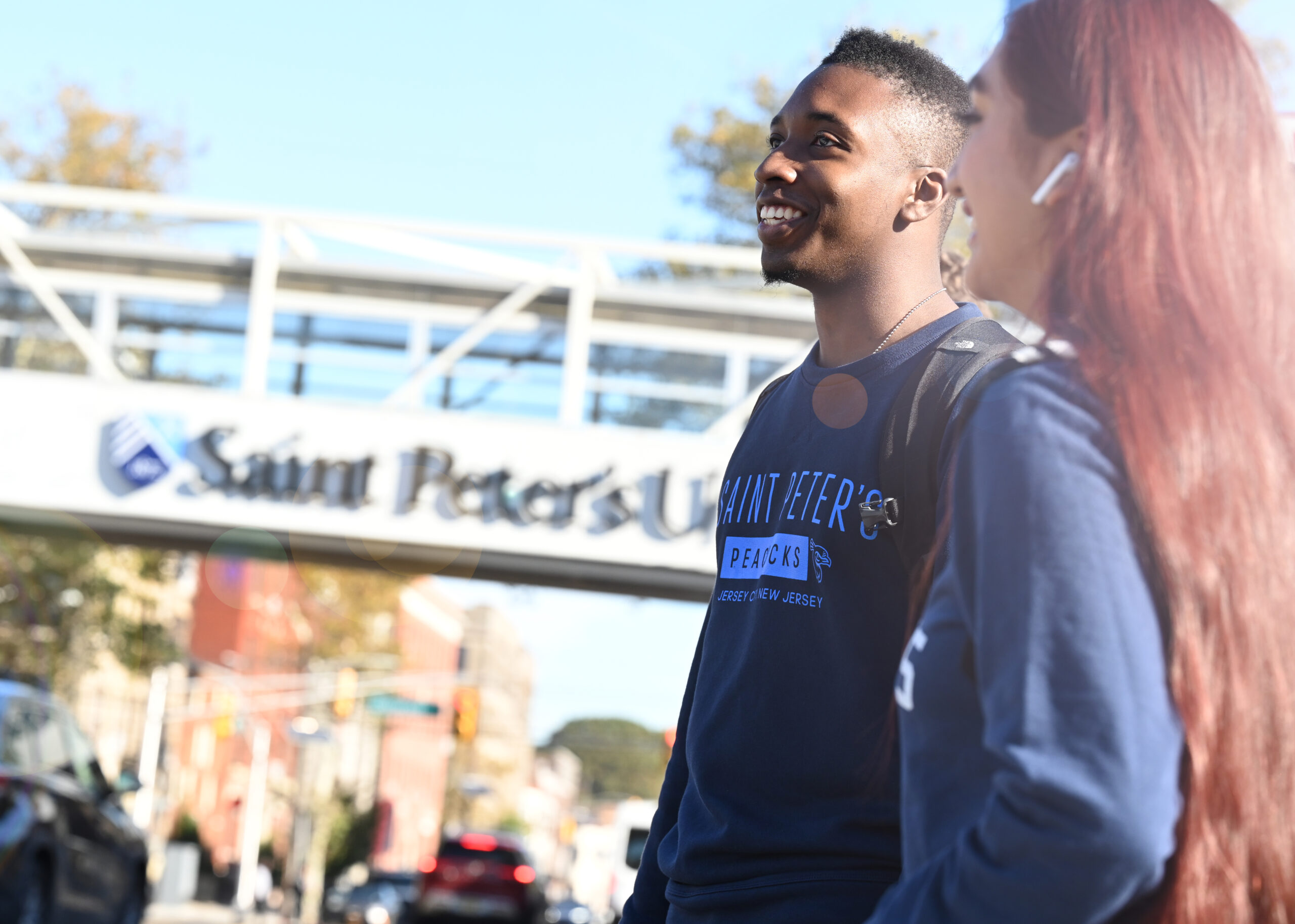 Saint Peter's University students walking near the bridge fall 2024