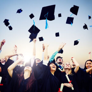 photo of graduates throwing caps in the air