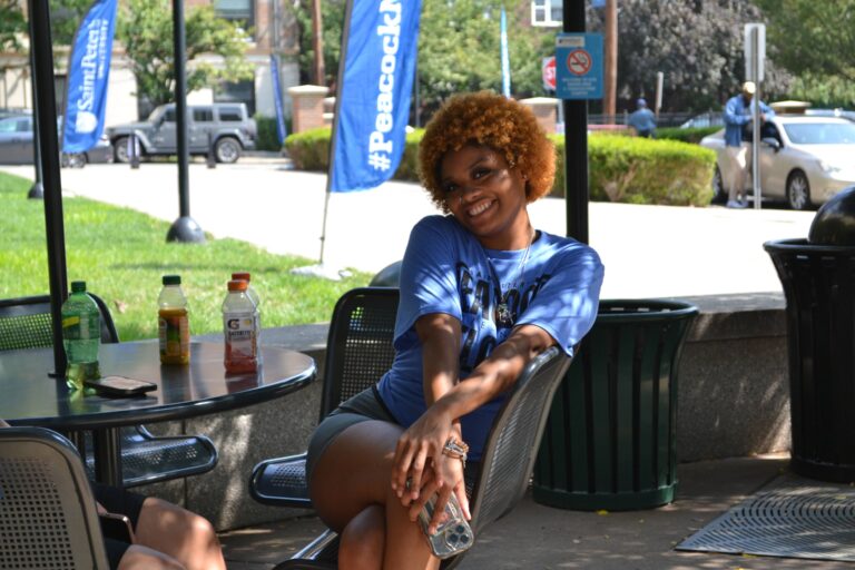 move-in volunteer posing in Panepinto Plaza