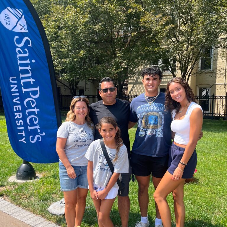 new student posing with her family